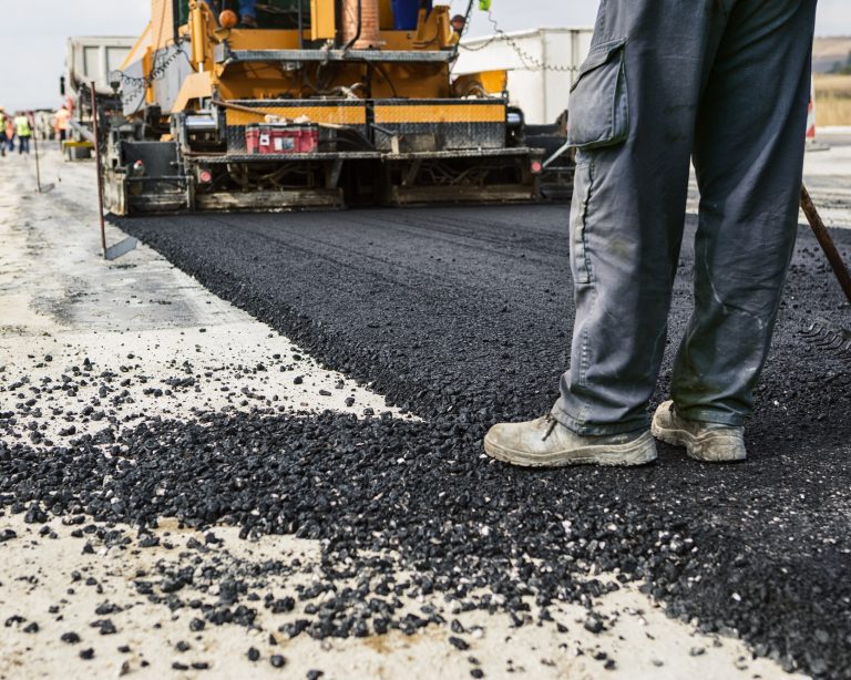 Worker,Operating,Asphalt,Paver,Machine,During,Road,Construction,And,Repairing